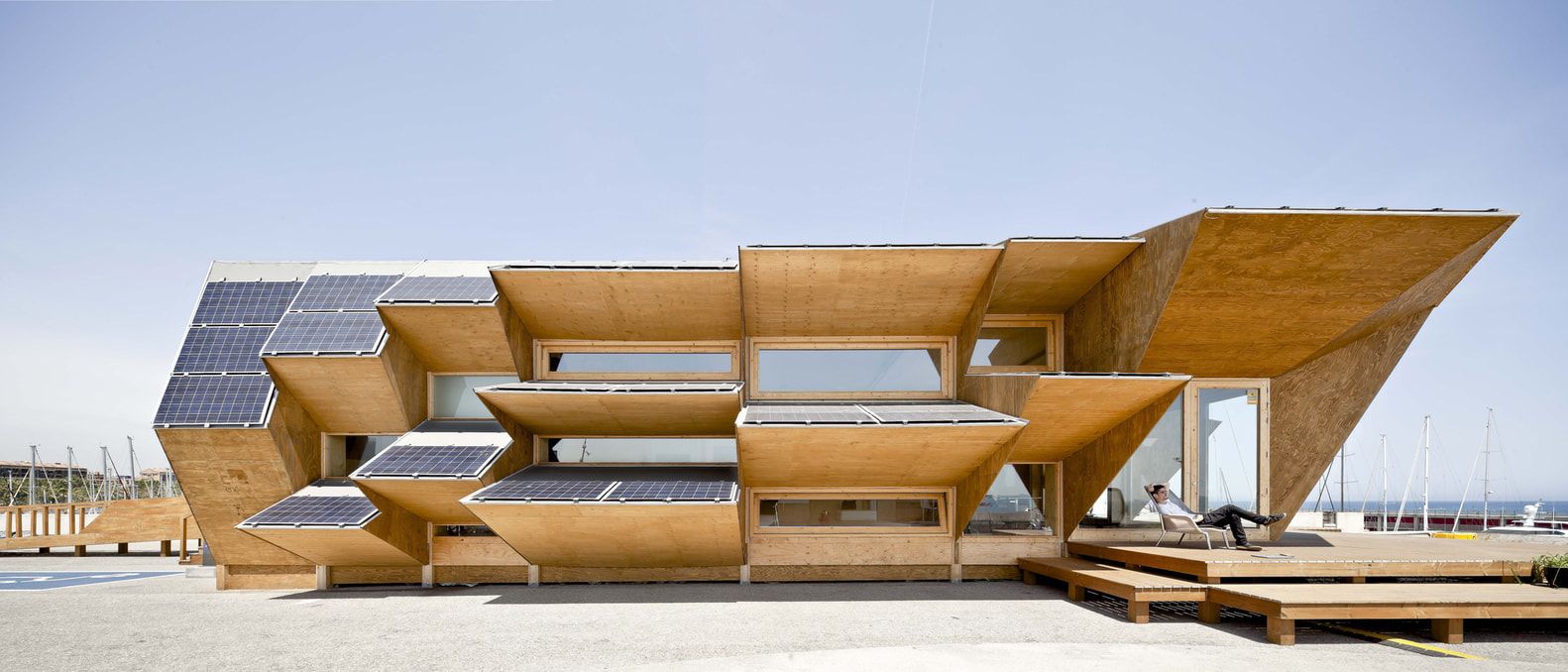 Endesa Pavilion on its site with a person resting on the front deck