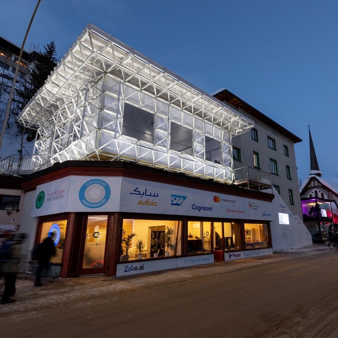 the lit up exterior of ICEHouse in Davos at dusk