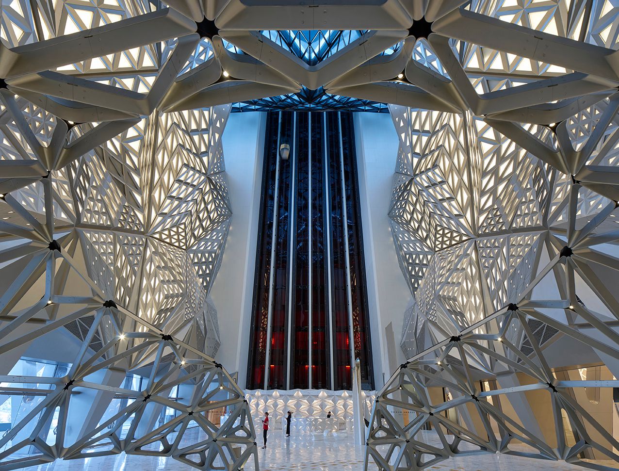 the dynamic interiors of Morpheus Hotel formed by triangular shapes protruding from the wall