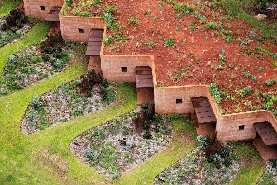 An aerial view of a building built into the earth