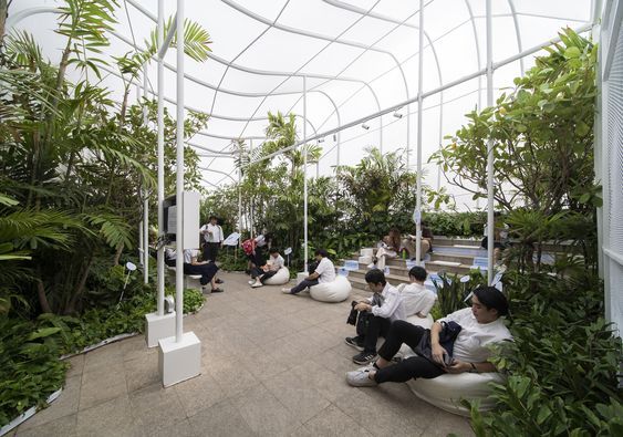 A cozy indoor landscape shelter where people can sit and relax