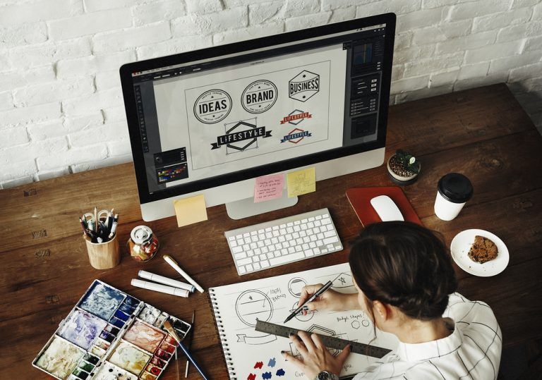 A designer sketching and designing logos