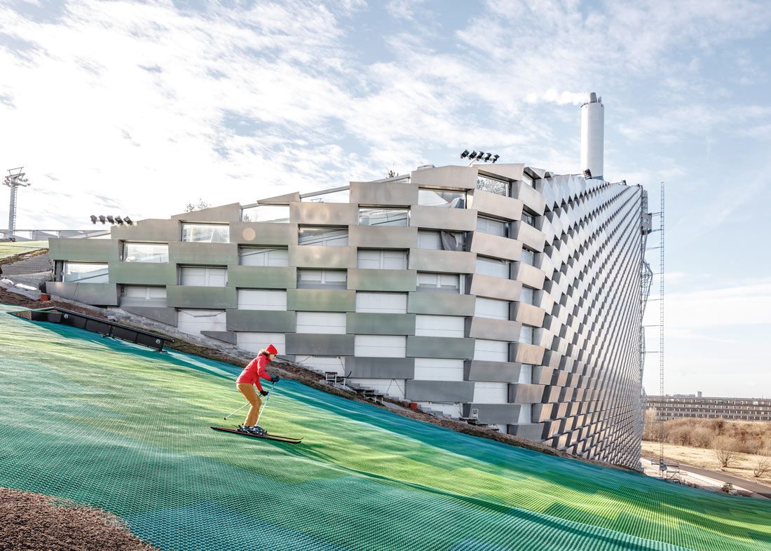 A view of the metal facade of the CopenHill from the side of the ski slope