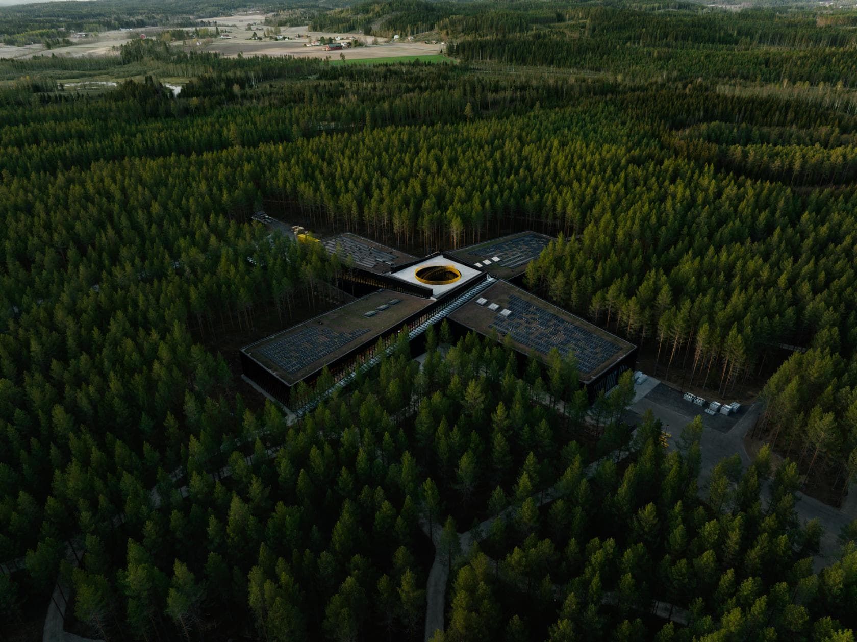 Architectural rendering of the PLUS building surrounded by the forest