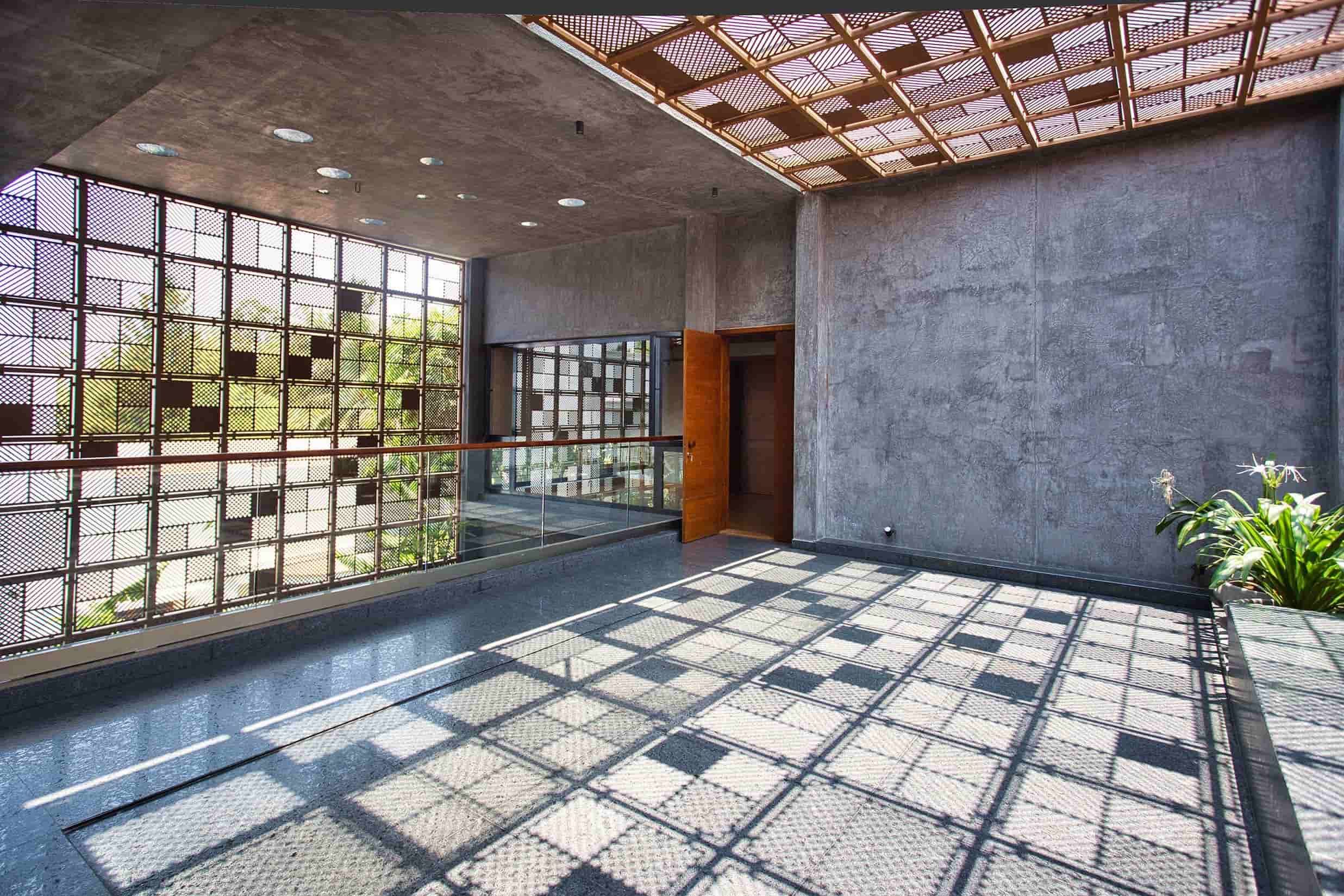 The upper floor deck with the sunlight filtering in from the top and front permeable screens