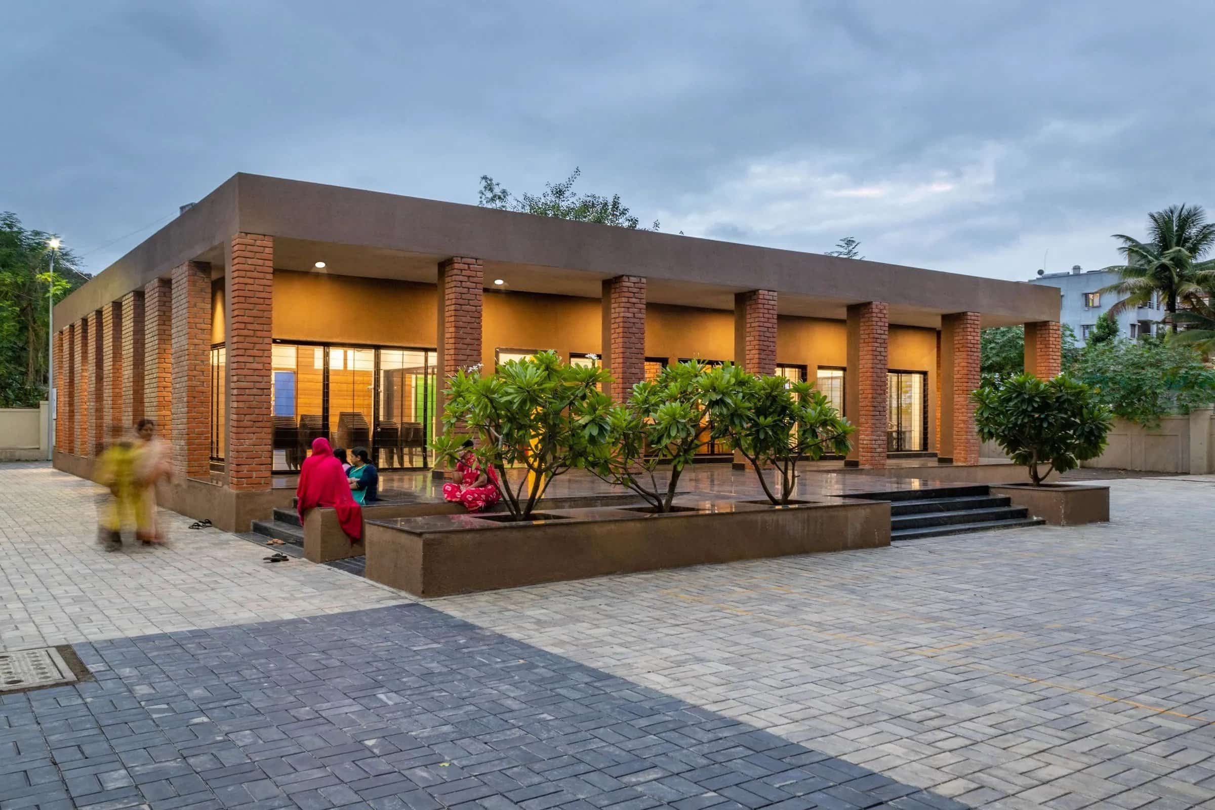 Red brick columns and stone flooring of Youth Empowerment Center in Pune