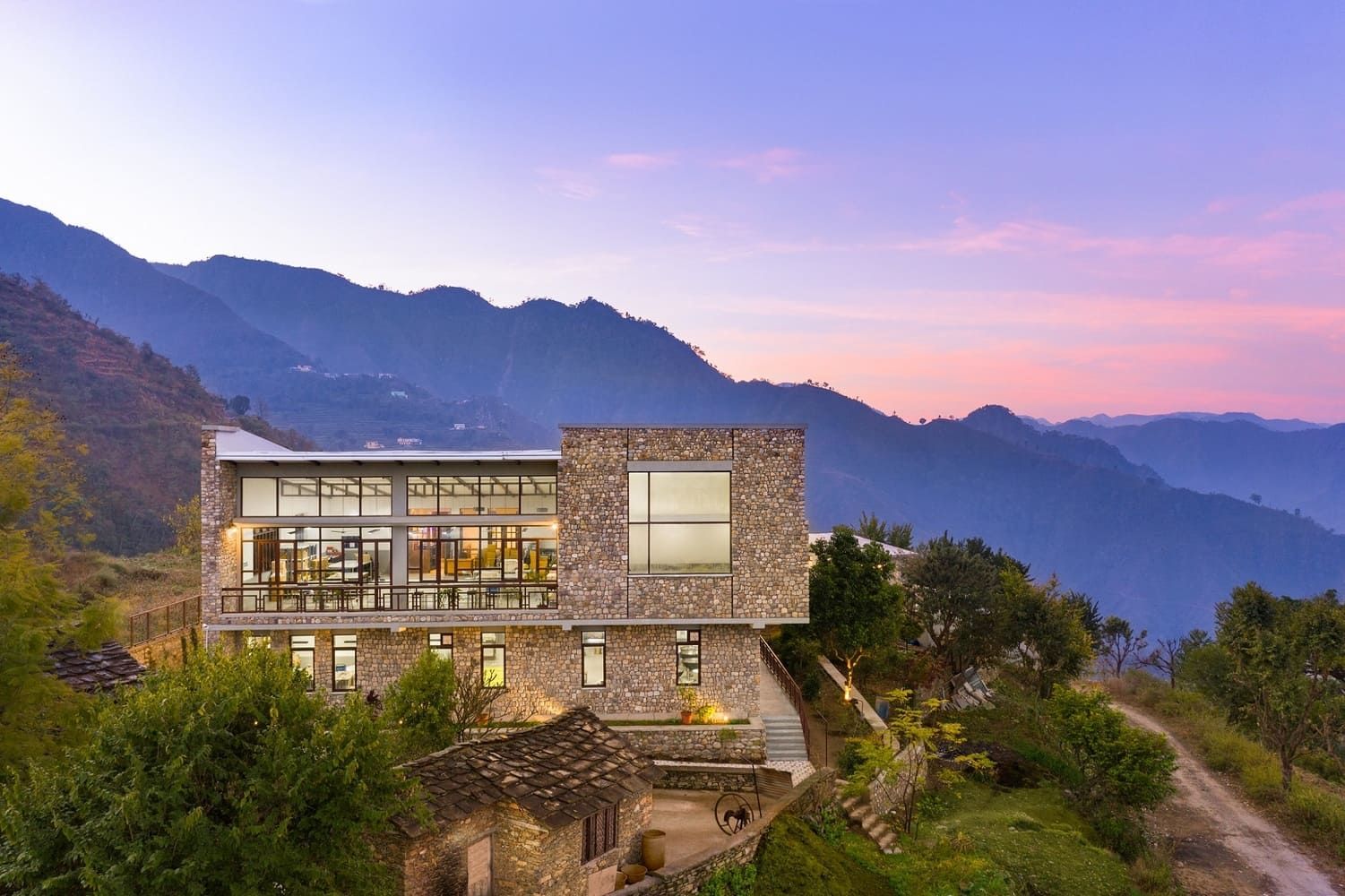 Building on a hilltop with mountains in the background